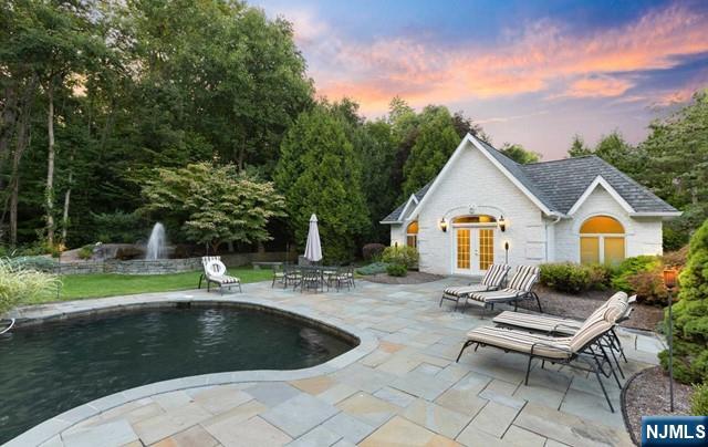 51 Chestnut Ridge Road Saddle River, NJ 07458 - Photo 36 of 45 a view of house with backyard outdoor seating and green space