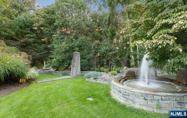 a front view of a house with a yard and outdoor seating