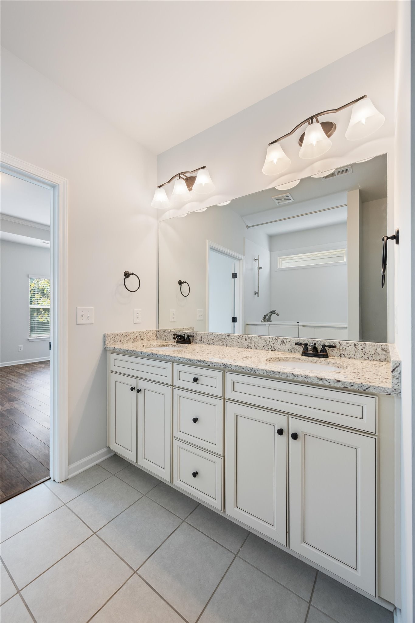 920 Carnation Drive Spring Hill, TN 37174 - Photo 17 of 27 a spacious bathroom with a granite countertop sink and a mirror