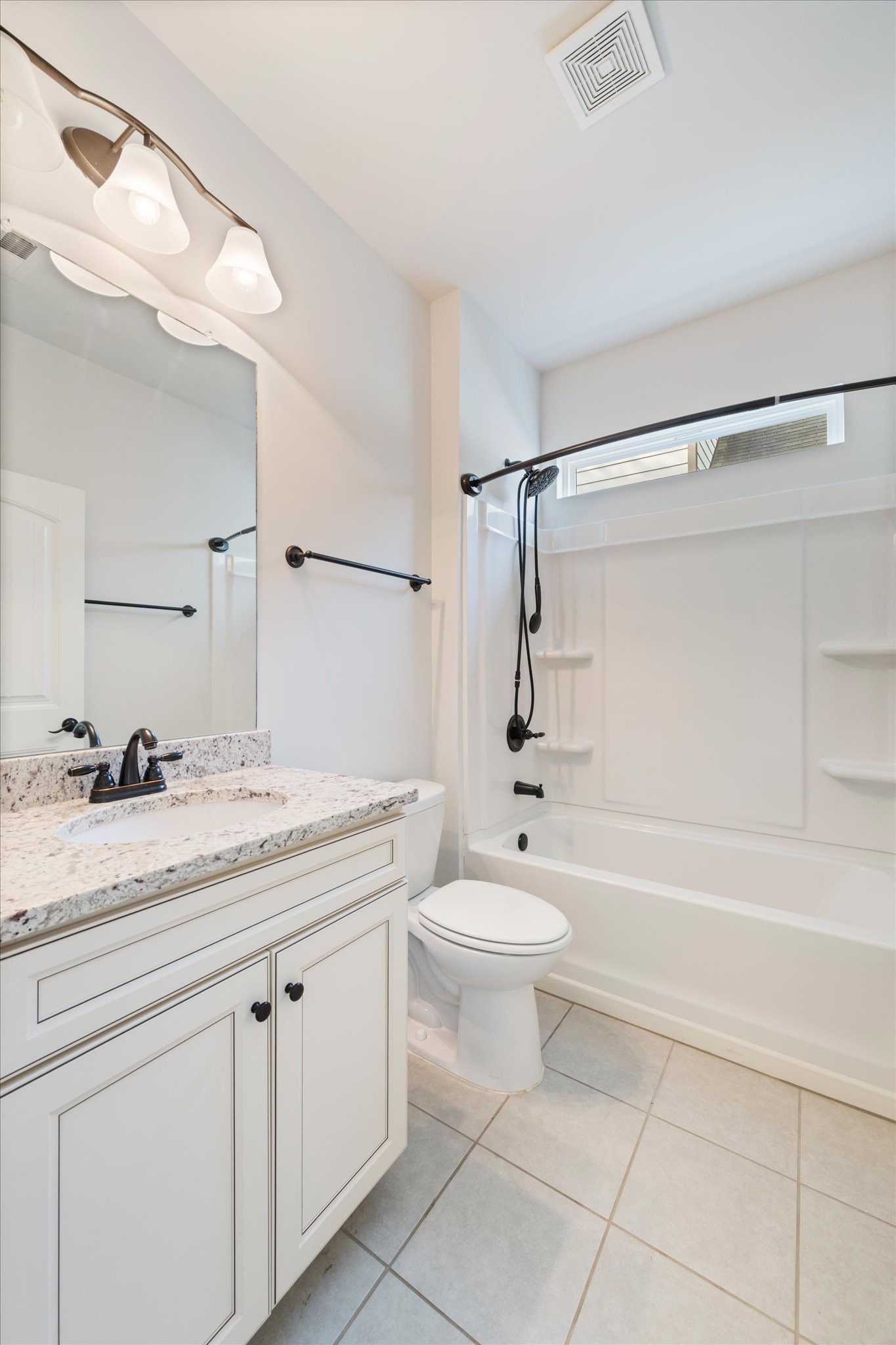 920 Carnation Drive Spring Hill, TN 37174 - Photo 20 of 27 a bathroom with a granite countertop sink a toilet mirror and bathtub