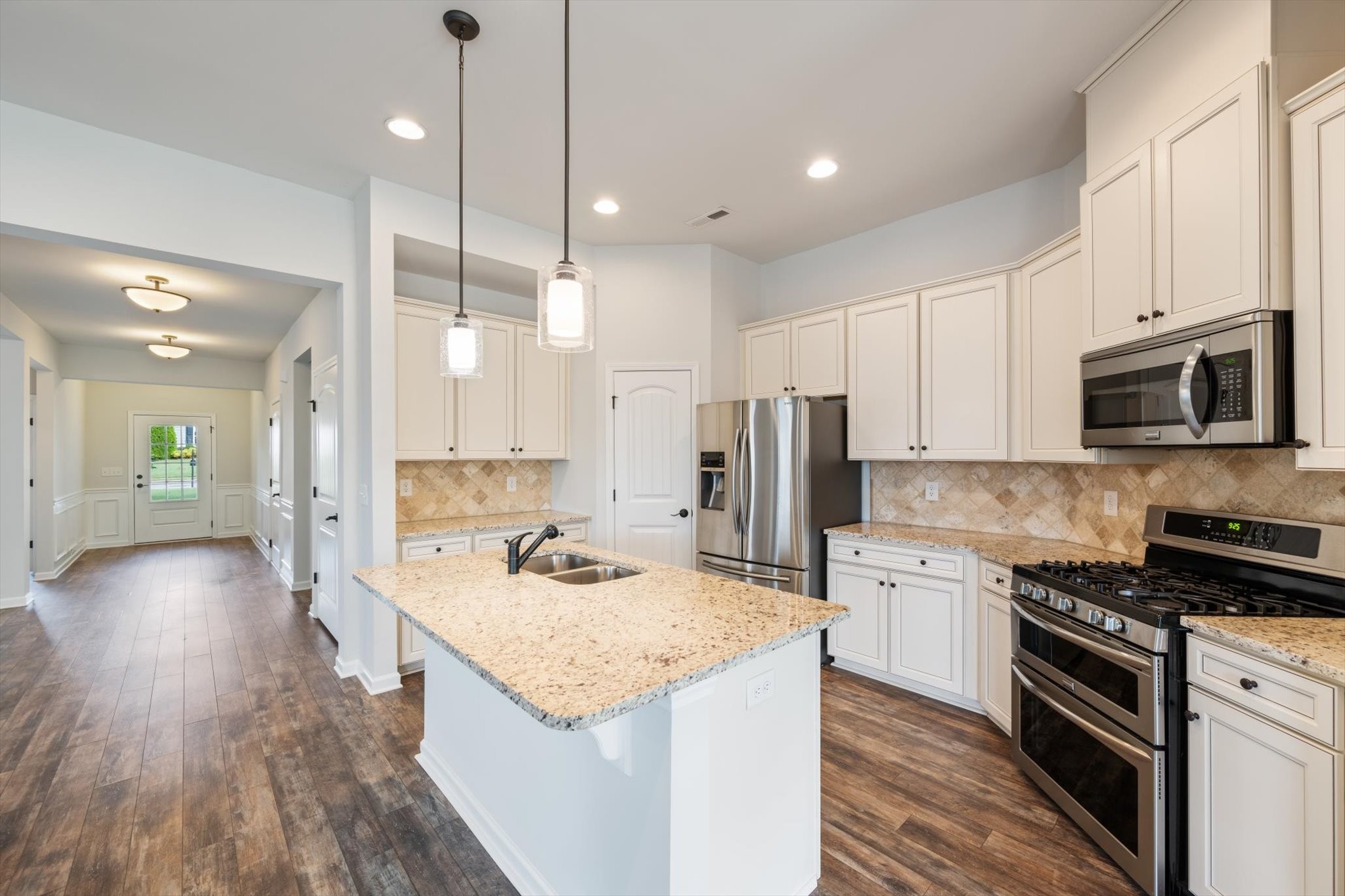920 Carnation Drive Spring Hill, TN 37174 - Photo 5 of 27 a kitchen with stainless steel appliances kitchen island granite countertop a stove a sink and a refrigerator