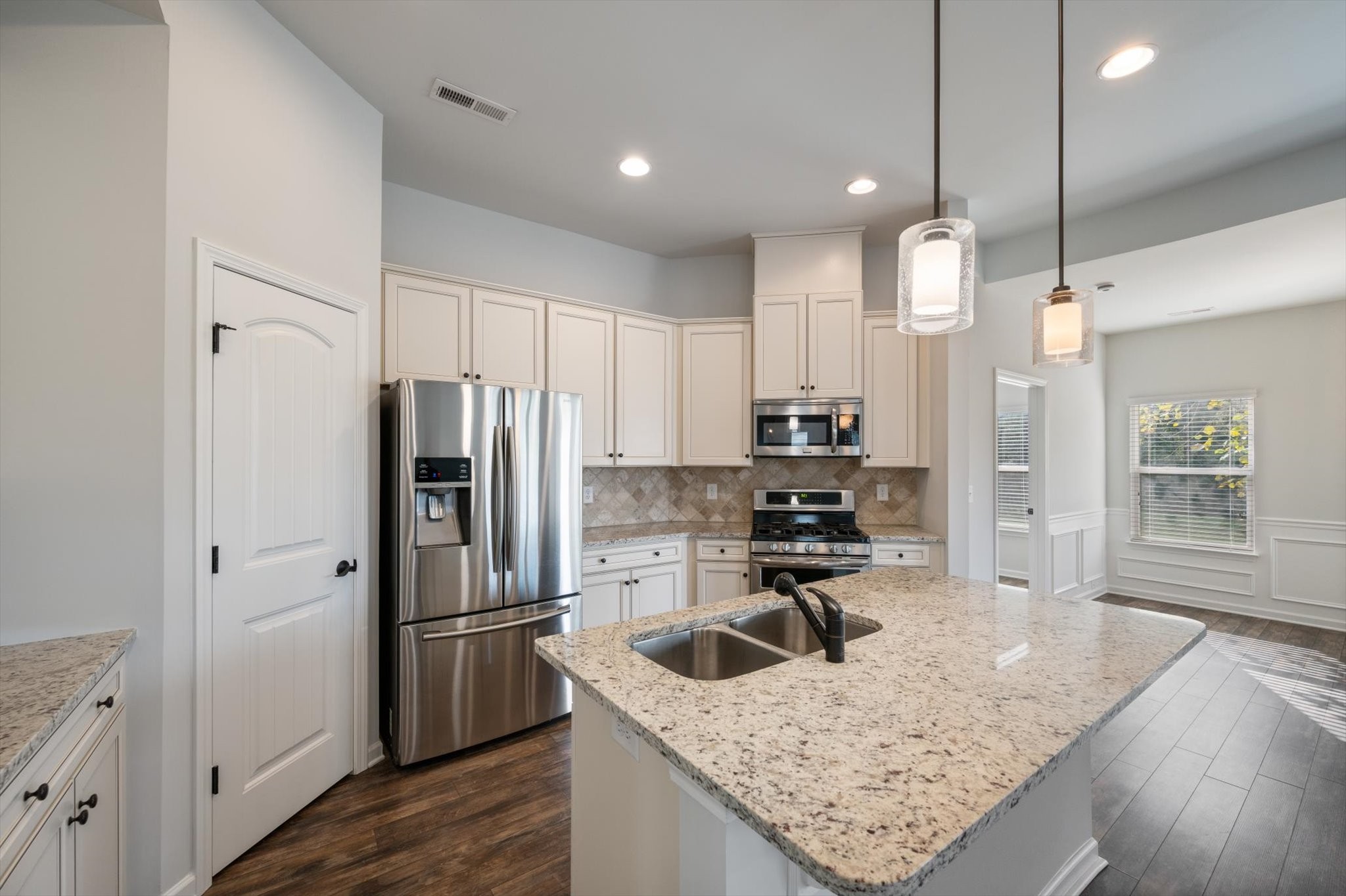 920 Carnation Drive Spring Hill, TN 37174 - Photo 7 of 27 a kitchen with a refrigerator a sink and wooden cabinets