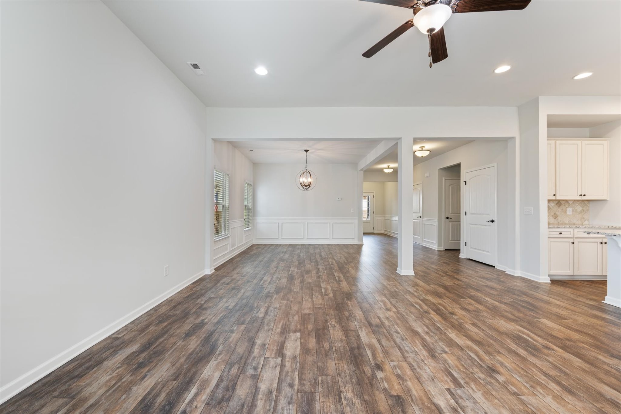 920 Carnation Drive Spring Hill, TN 37174 - Photo 10 of 27 a view of a hallway with wooden floor and a ceiling fan