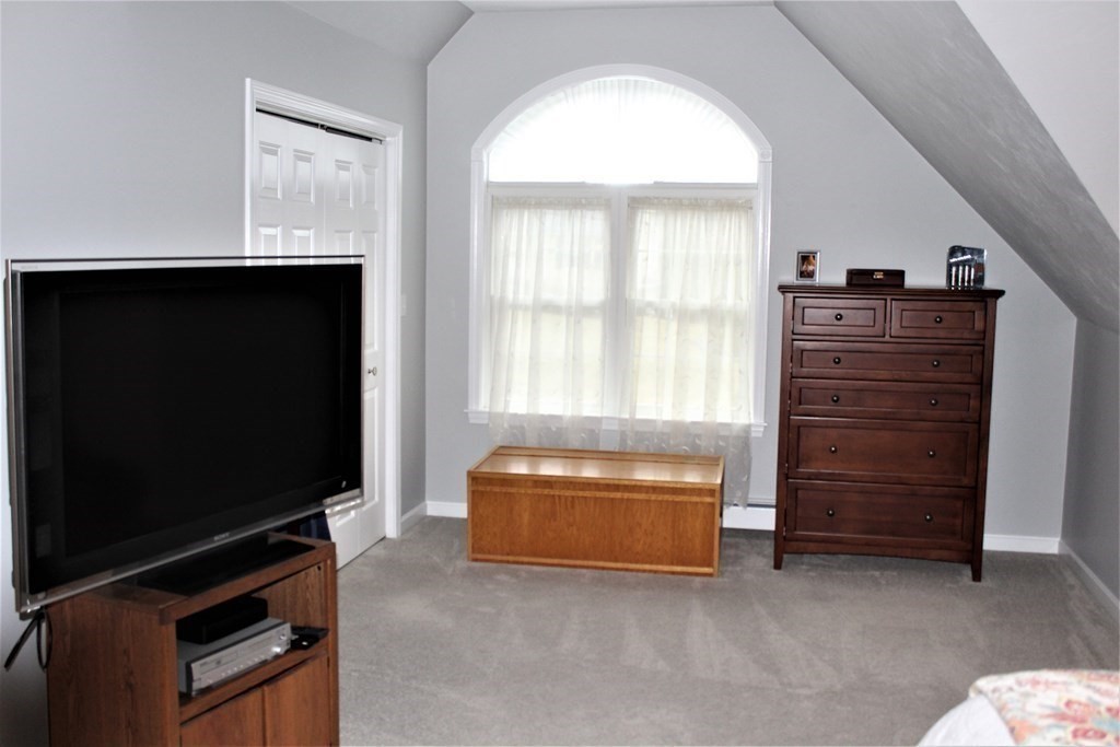 7 Michael Road Franklin, MA 02038 - Photo 23 of 26 a living room with furniture and a flat screen tv