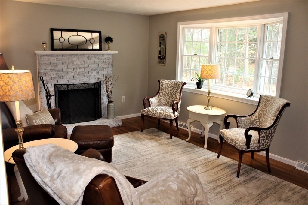 7 Michael Road Franklin, MA 02038 - Photo 6 of 26 a living room with furniture and a fireplace