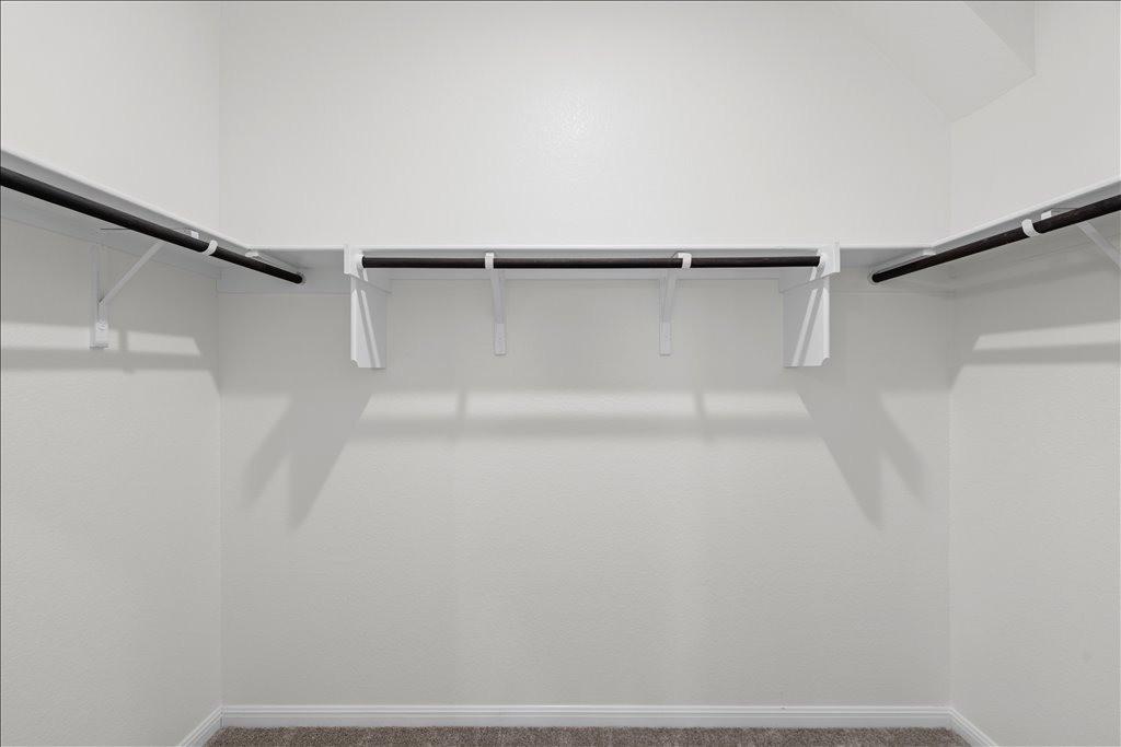 158 Gullivers Drive Elgin, TX 78621 - Photo 20 of 36 And right through the bathroom is this great walk-in closet. It is fully wrapped with hanging rods and built-in shelving above, giving you tons of room for a full wardrobe and extra storage.