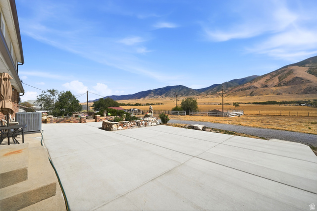 4468 North Droubay Road Tooele, UT 84074 - Photo 36 of 60 Expansive concrete patio with brick and stone planter beds