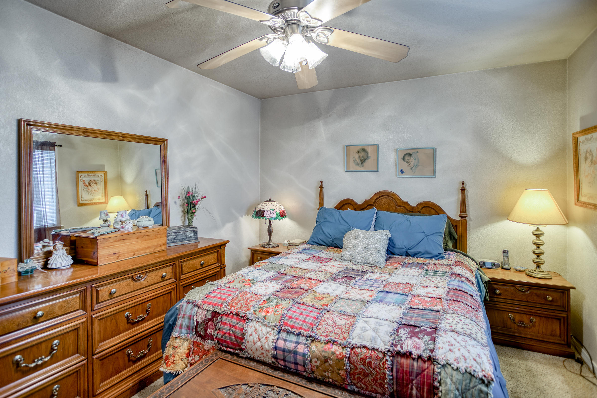 2851 Irwin Road Redding, CA 96002 - Photo 12 of 28 a bedroom with a bed and a chandelier