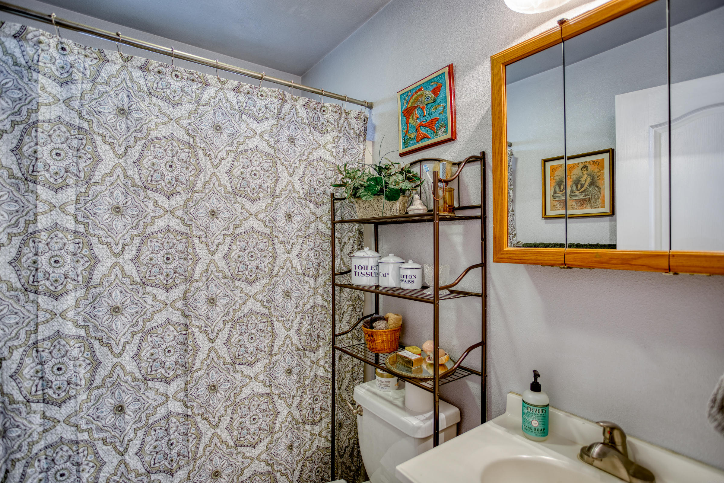 2851 Irwin Road Redding, CA 96002 - Photo 13 of 28 a bathroom with a toilet and a shower curtain