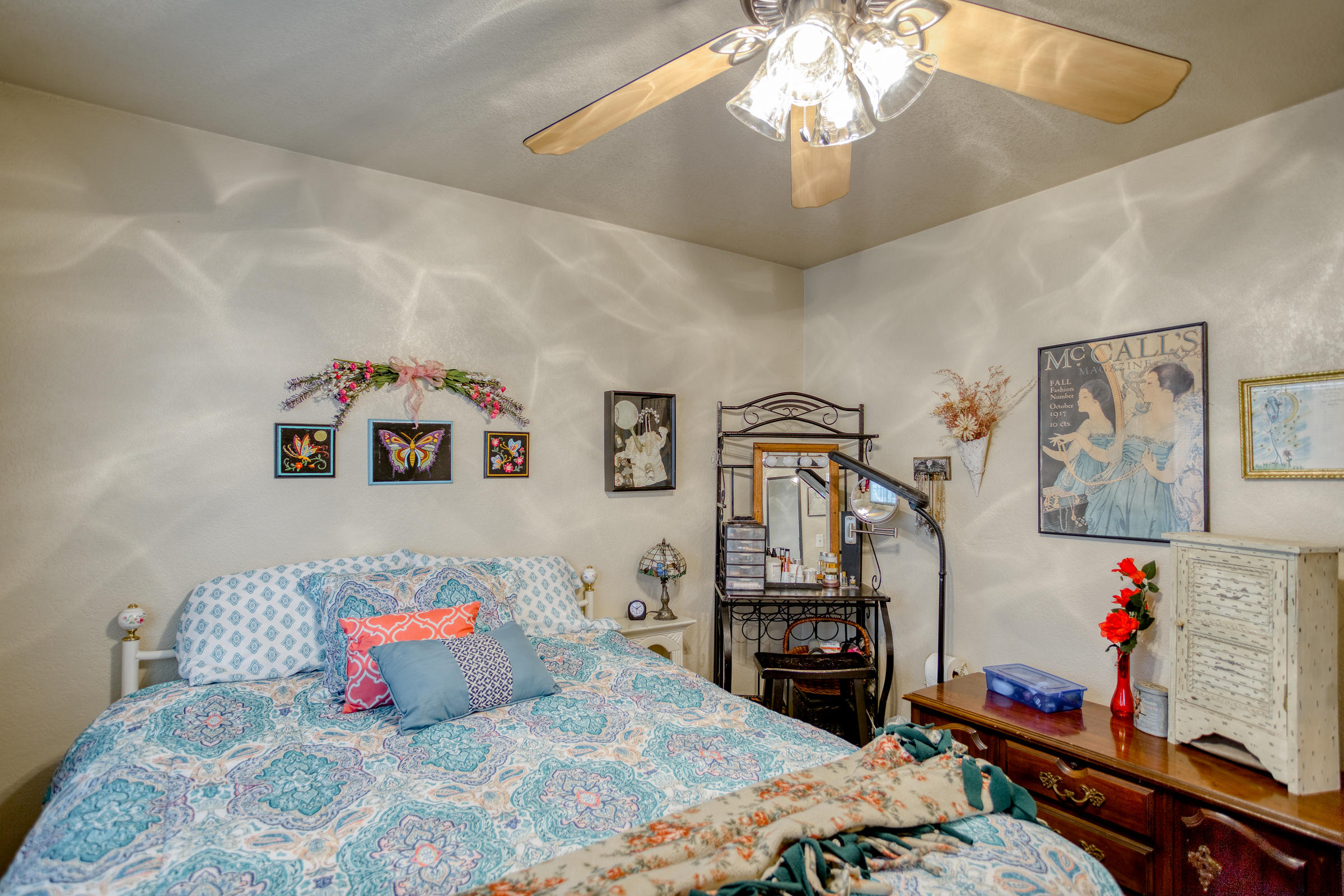 2851 Irwin Road Redding, CA 96002 - Photo 14 of 28 a bedroom with a bed and a chandelier