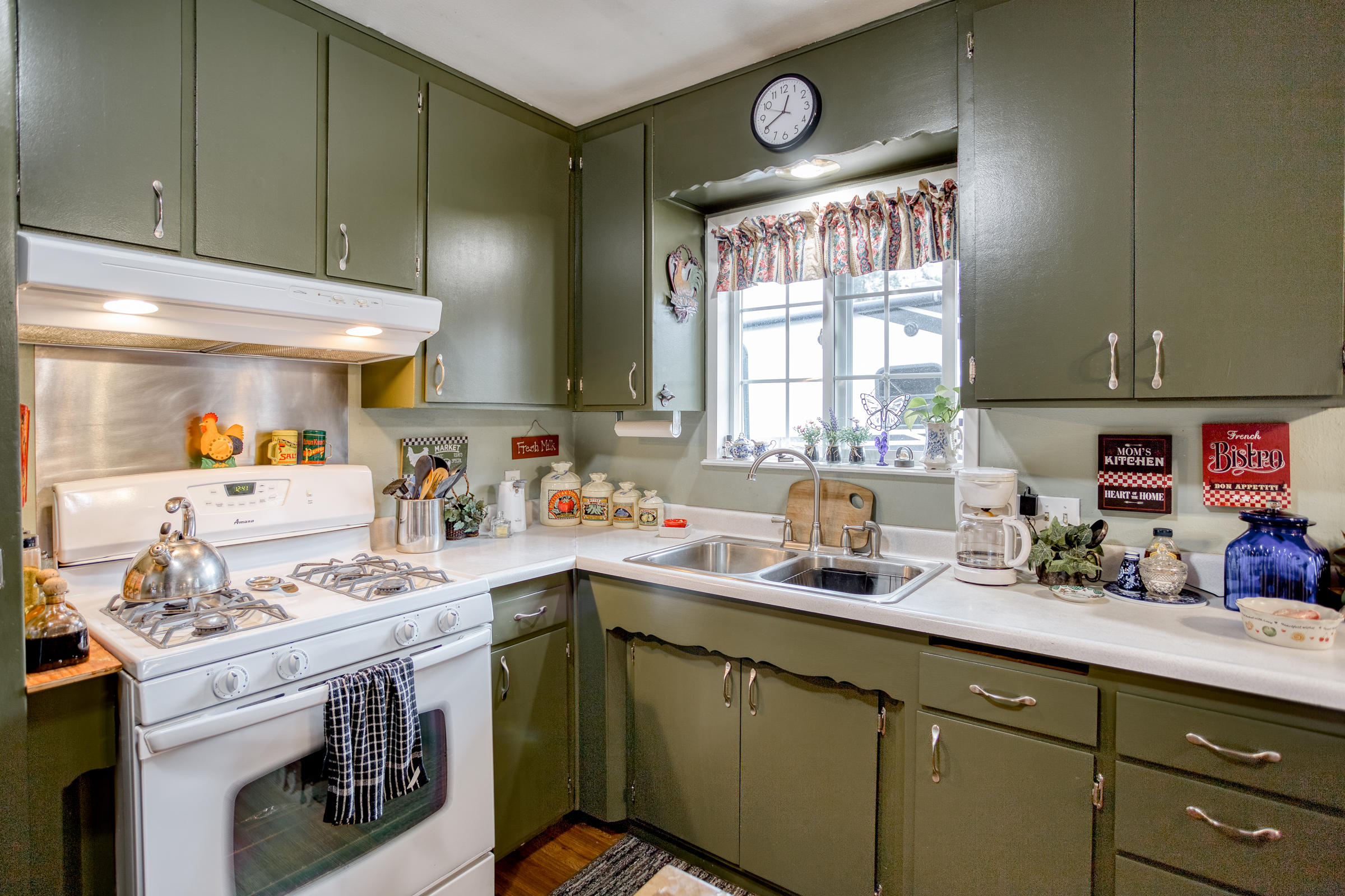 2851 Irwin Road Redding, CA 96002 - Photo 10 of 28 a kitchen with a sink cabinets and window