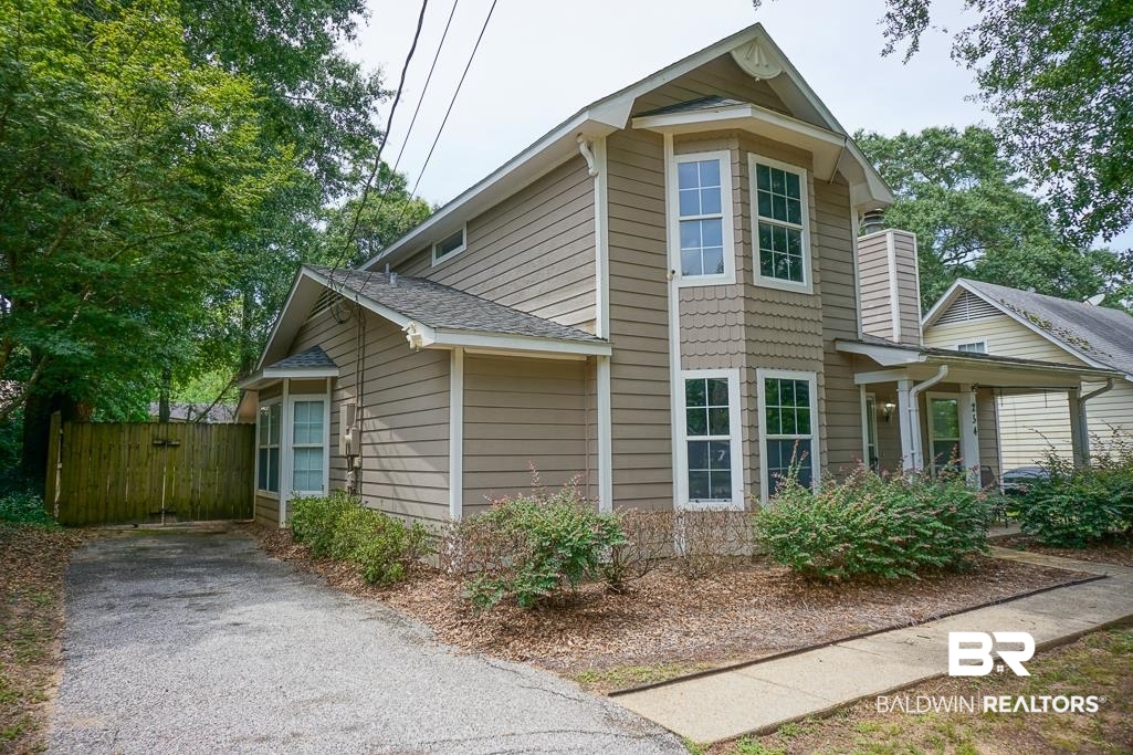 254 Thrift Street Mobile, AL 36609 - Photo 2 of 16 View of property exterior with a shingled roof and a gate