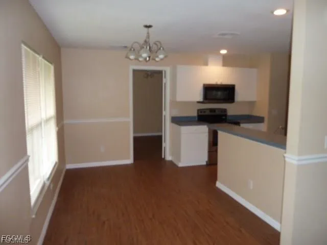 a kitchen with stainless steel appliances a microwave a stove and a refrigerator