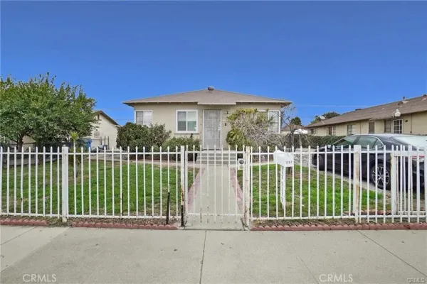 a view of a house with a small yard and plants