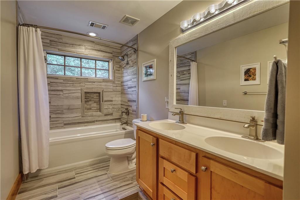 393 Edwards Road Oxford, GA 30054 - Photo 33 of 82 a bathroom with a sink a toilet a mirror and shower