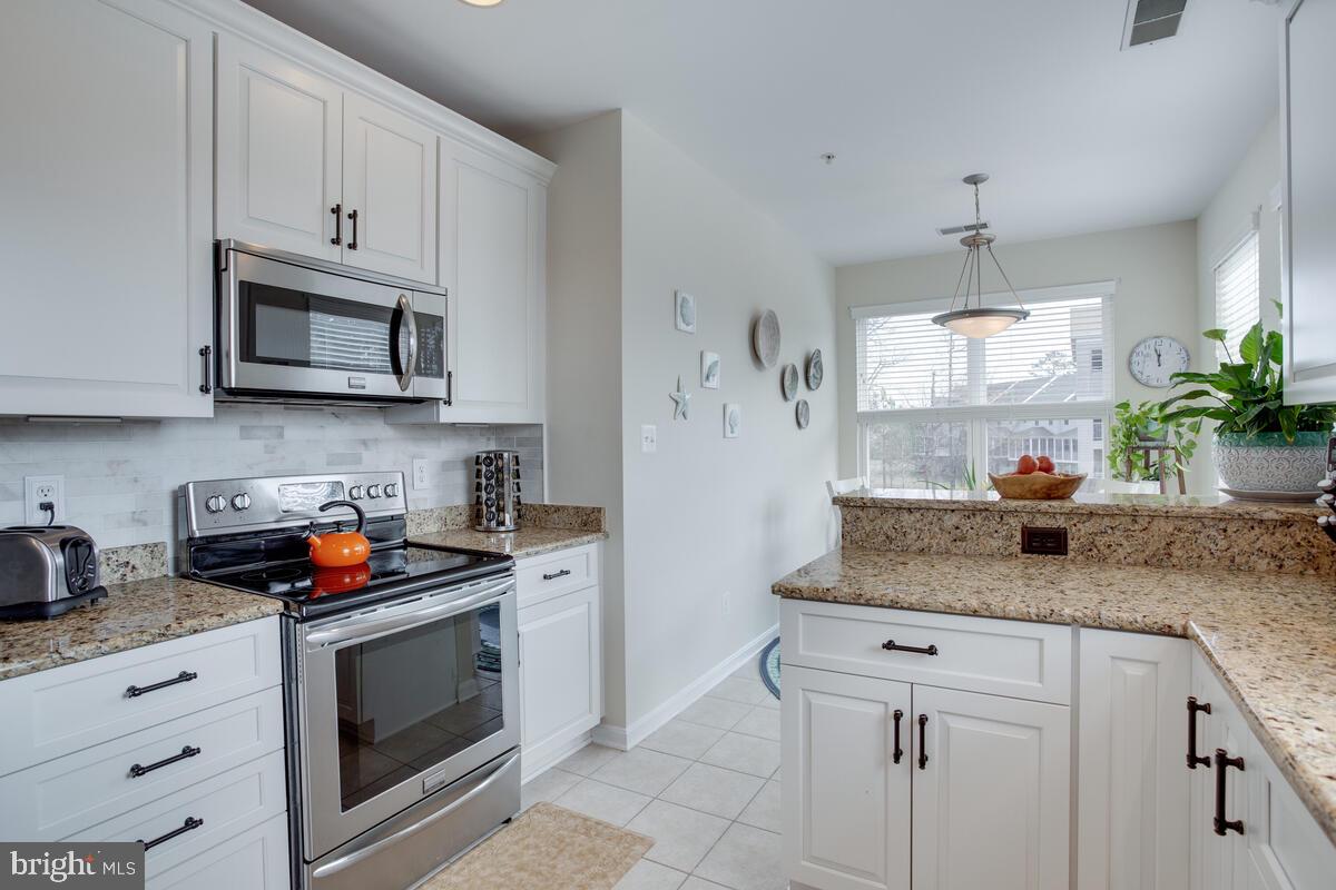 13824 Reef Way, Unit 301 Solomons, MD 20688 - Photo 14 of 64 Lots of beautiful white cabinets.