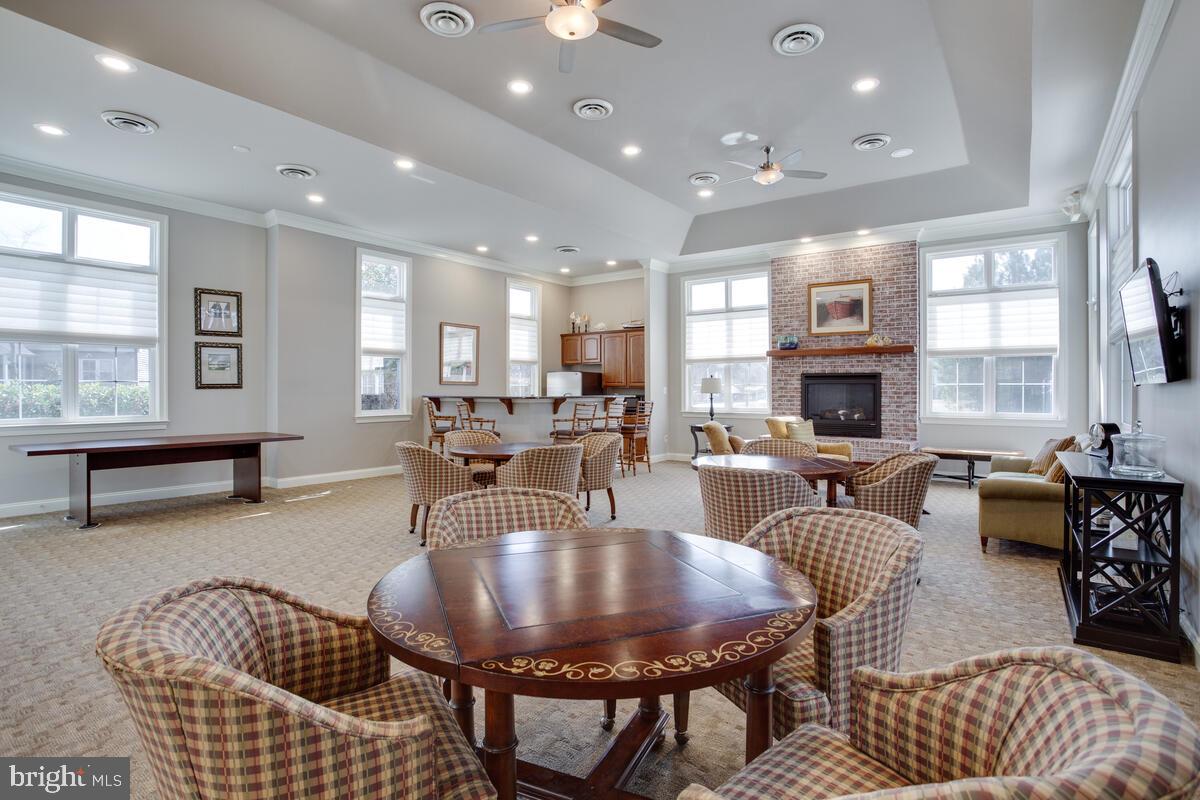 13824 Reef Way, Unit 301 Solomons, MD 20688 - Photo 43 of 64 Clubhouse has kitchen, TV and fireplace