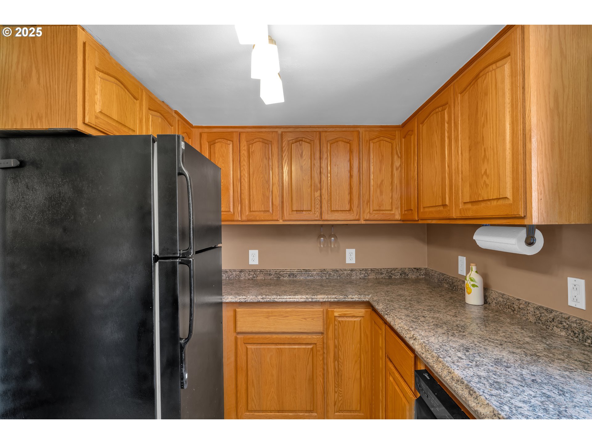 630 Colonial Drive Springfield, OR 97477 - Photo 14 of 37 a kitchen with stainless steel appliances granite countertop a refrigerator a sink dishwasher with granite countertops and cabinets