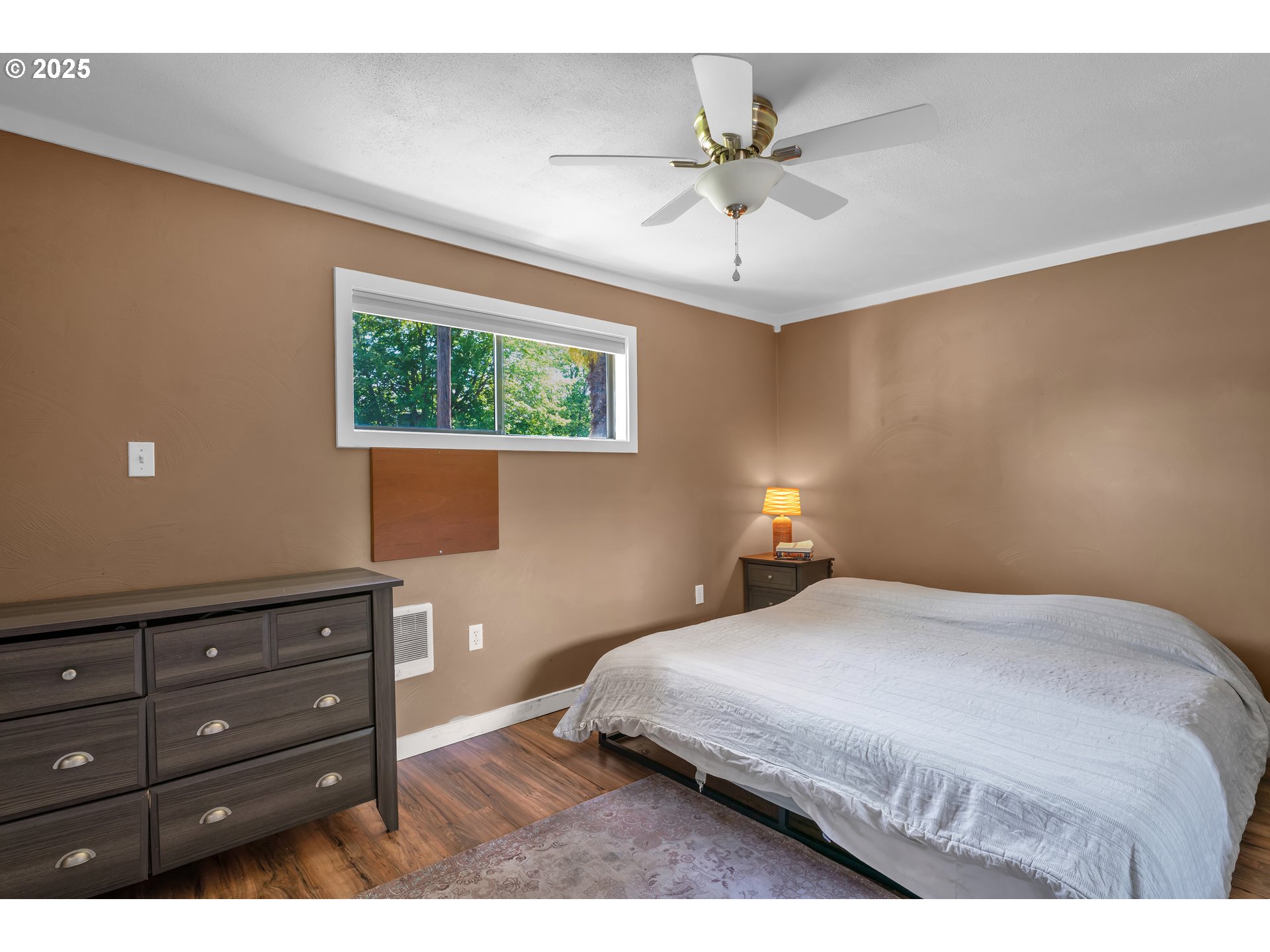 630 Colonial Drive Springfield, OR 97477 - Photo 20 of 37 a bedroom with a bed and a chandelier