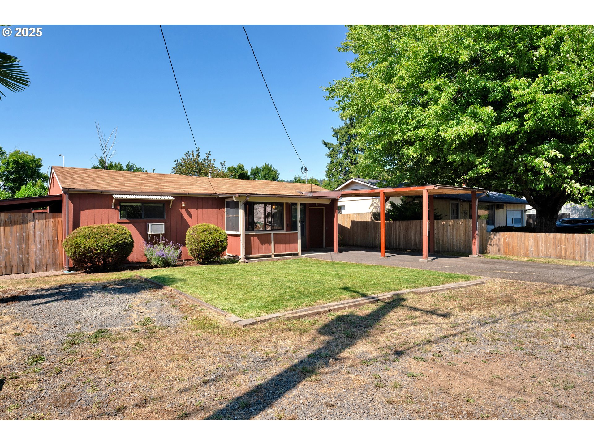 630 Colonial Drive Springfield, OR 97477 - Photo 3 of 37 a front view of a house with a yard and potted plants