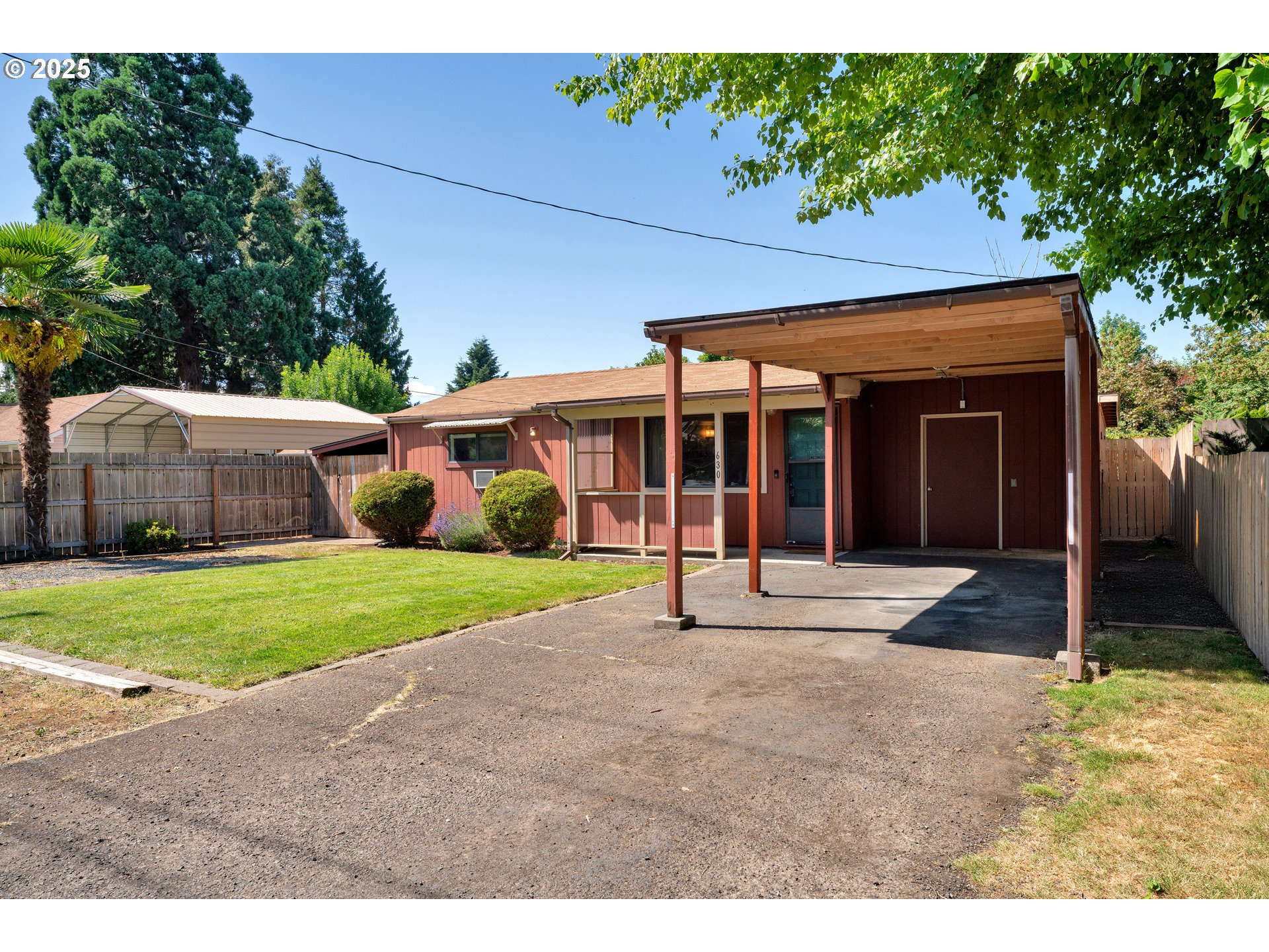 630 Colonial Drive Springfield, OR 97477 - Photo 5 of 37 a front view of a house with a yard and potted plants