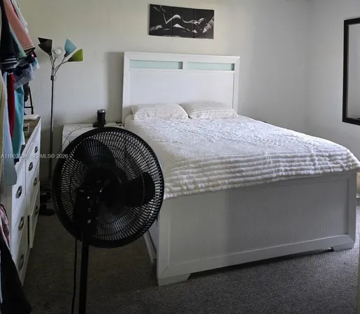 a bedroom with a bed and a table in it