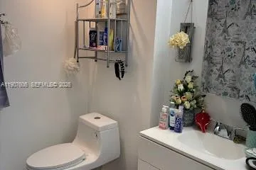 a bathroom with a toilet sink and mirror