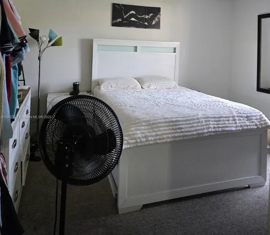 a bedroom with a bed and a table in it