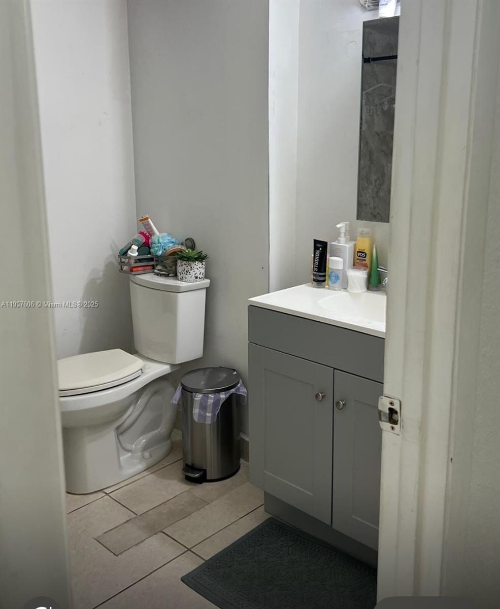 17600 Northwest 68th Avenue, Unit B4002 Hialeah, FL 33015 - Photo 5 of 7 a bathroom with a toilet sink and mirror