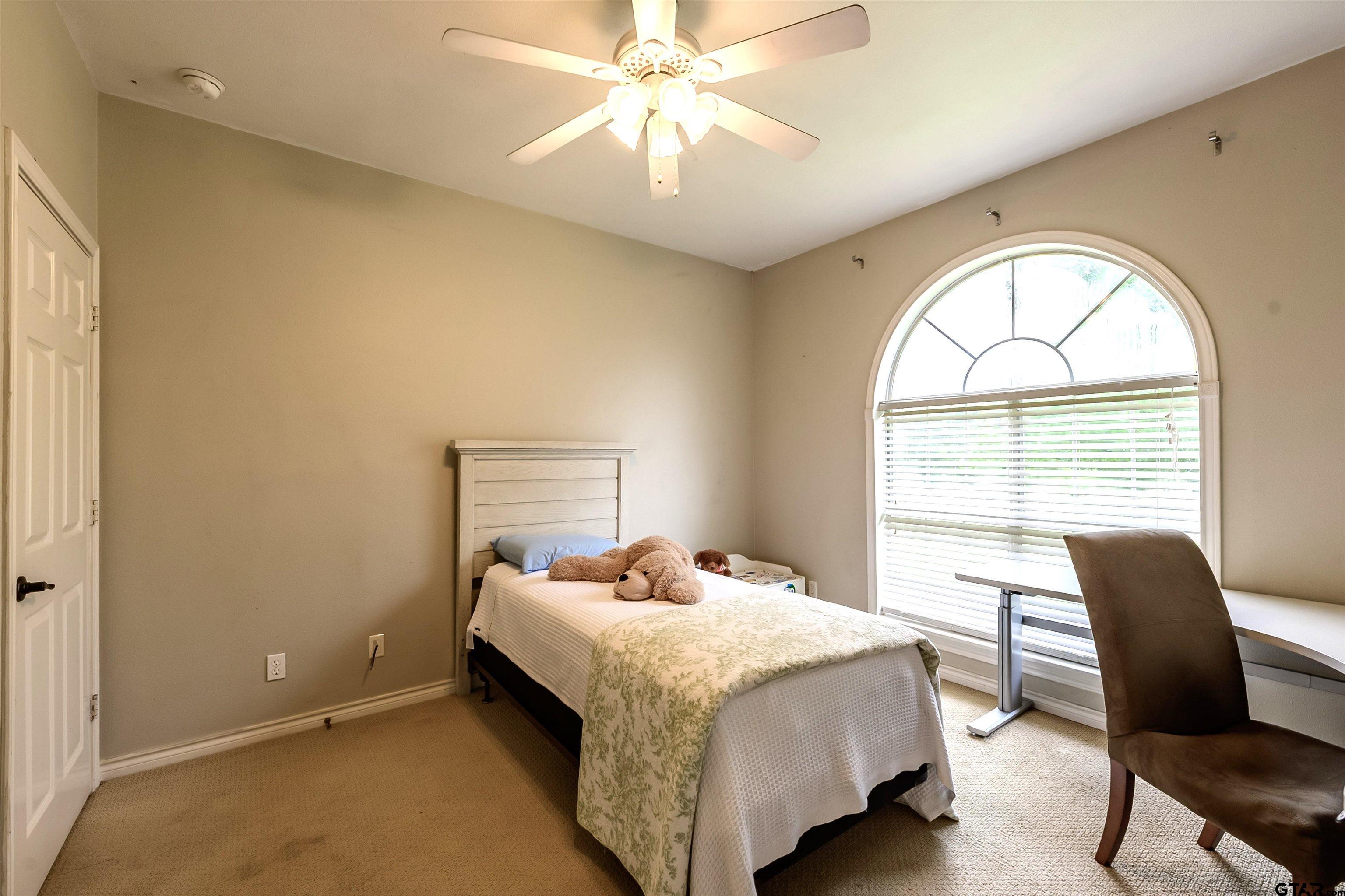 10074 Hillside Lane Flint, TX 75762 - Photo 17 of 22 a bedroom with a bed and a chair
