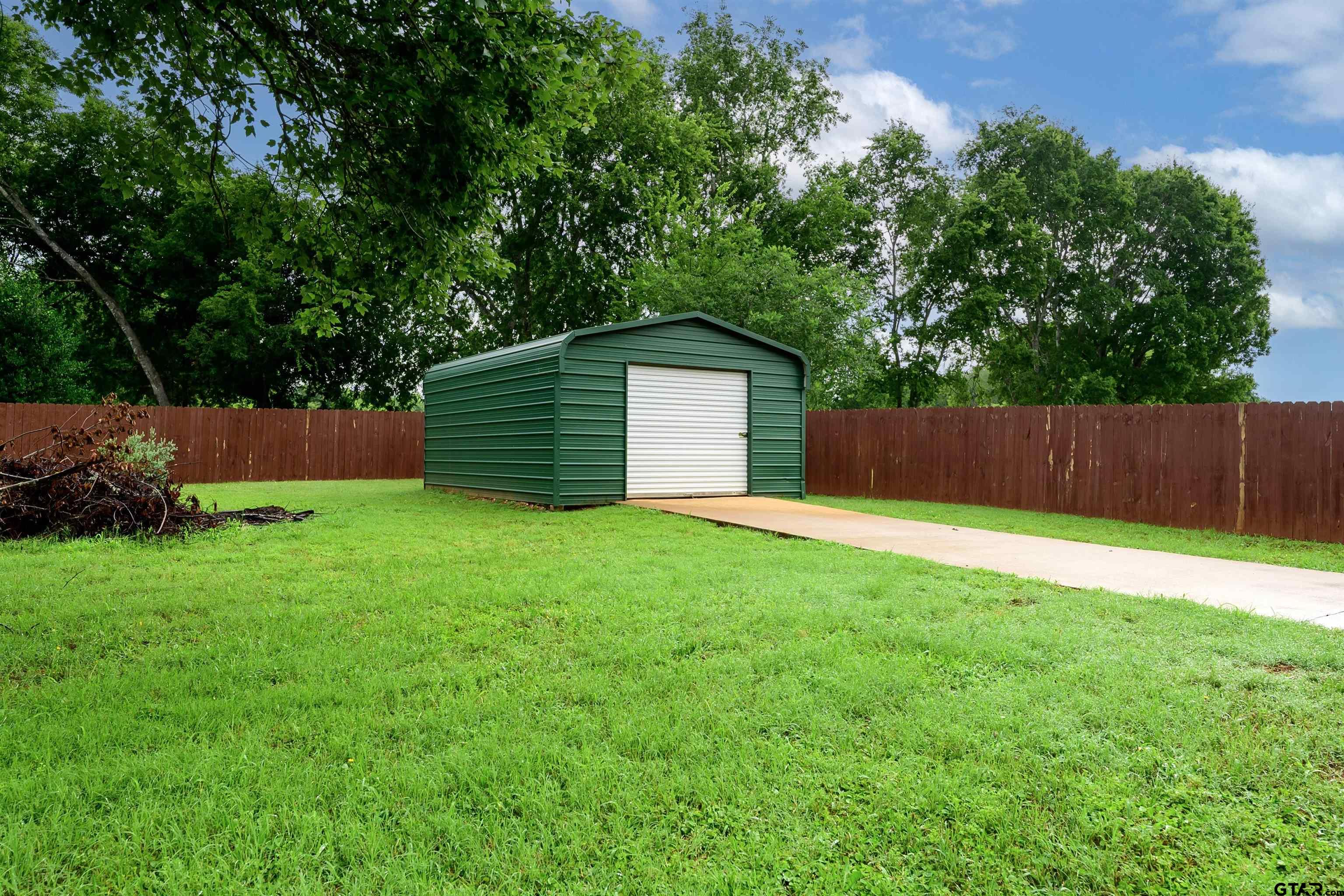 10074 Hillside Lane Flint, TX 75762 - Photo 21 of 22 a backyard of a house with lots of green space