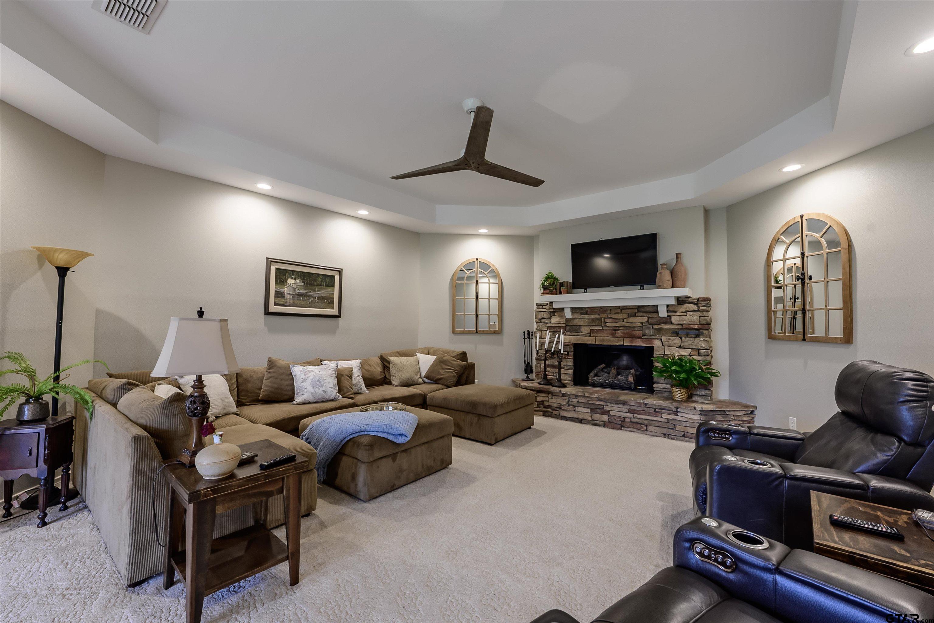 10074 Hillside Lane Flint, TX 75762 - Photo 4 of 22 a living room with furniture a fireplace and a flat screen tv