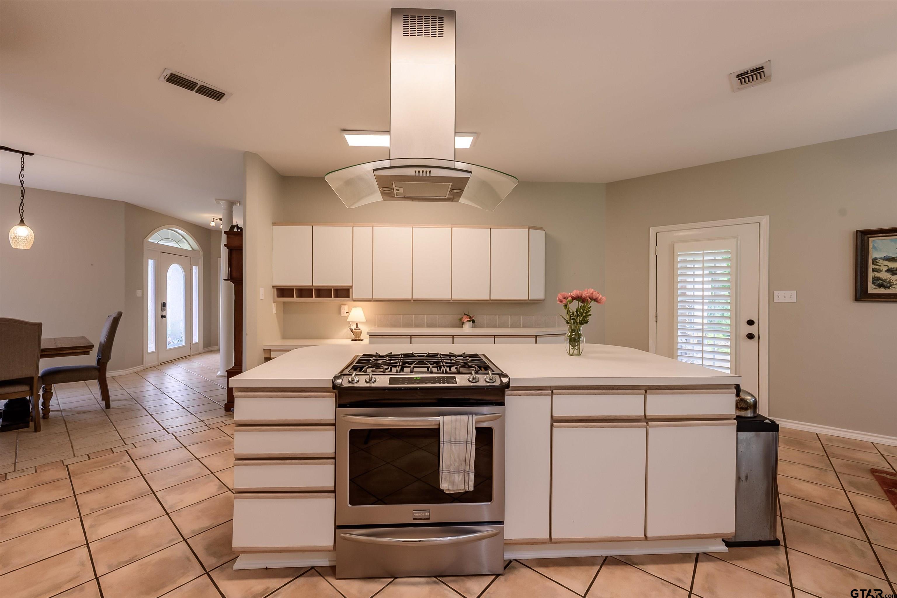 10074 Hillside Lane Flint, TX 75762 - Photo 7 of 22 a kitchen with a stove cabinets and chairs