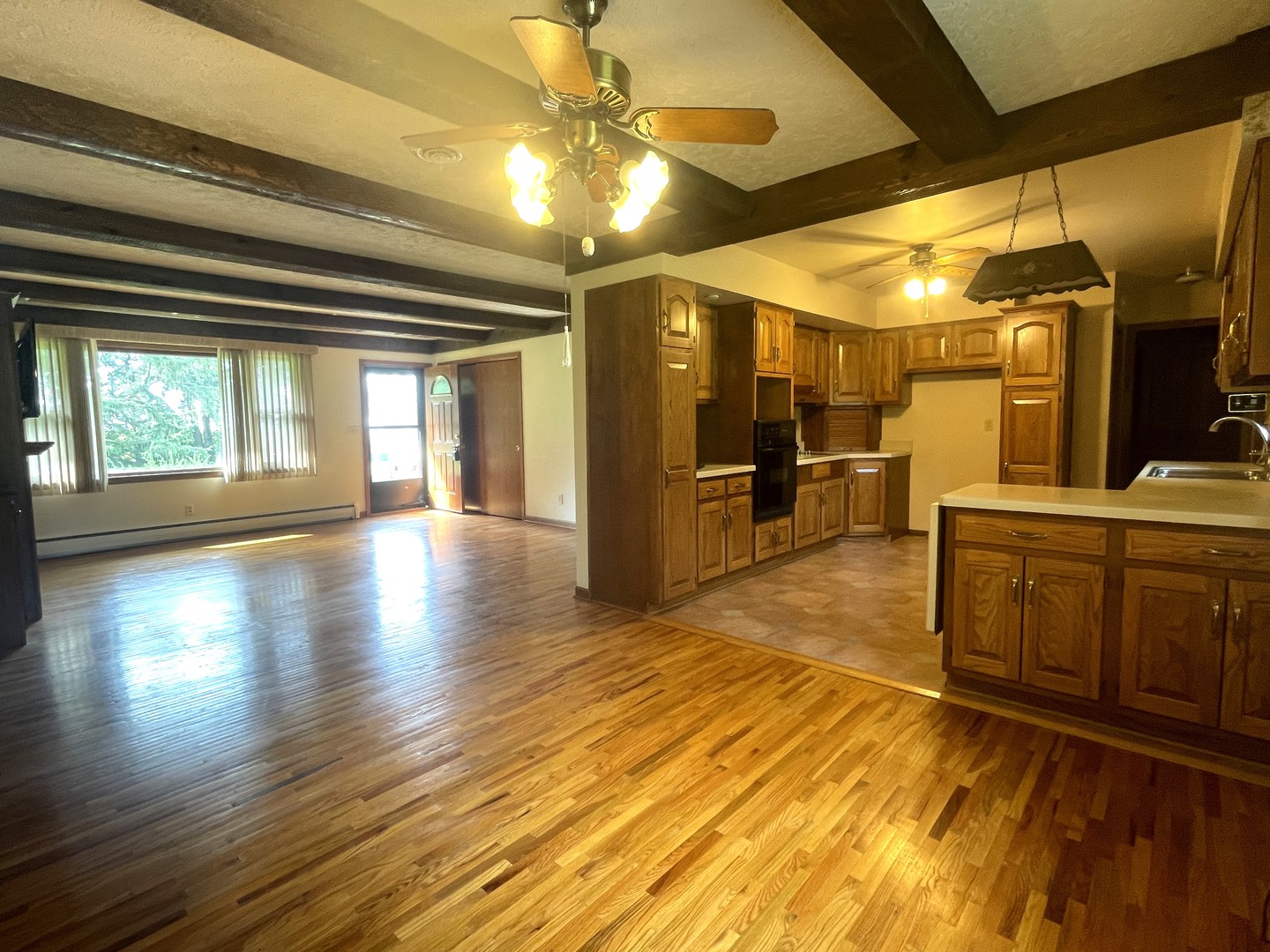 206 Palmyra Road Dixon, IL 61021 - Photo 12 of 46 a view of a livingroom with furniture a kitchen view and wooden floor