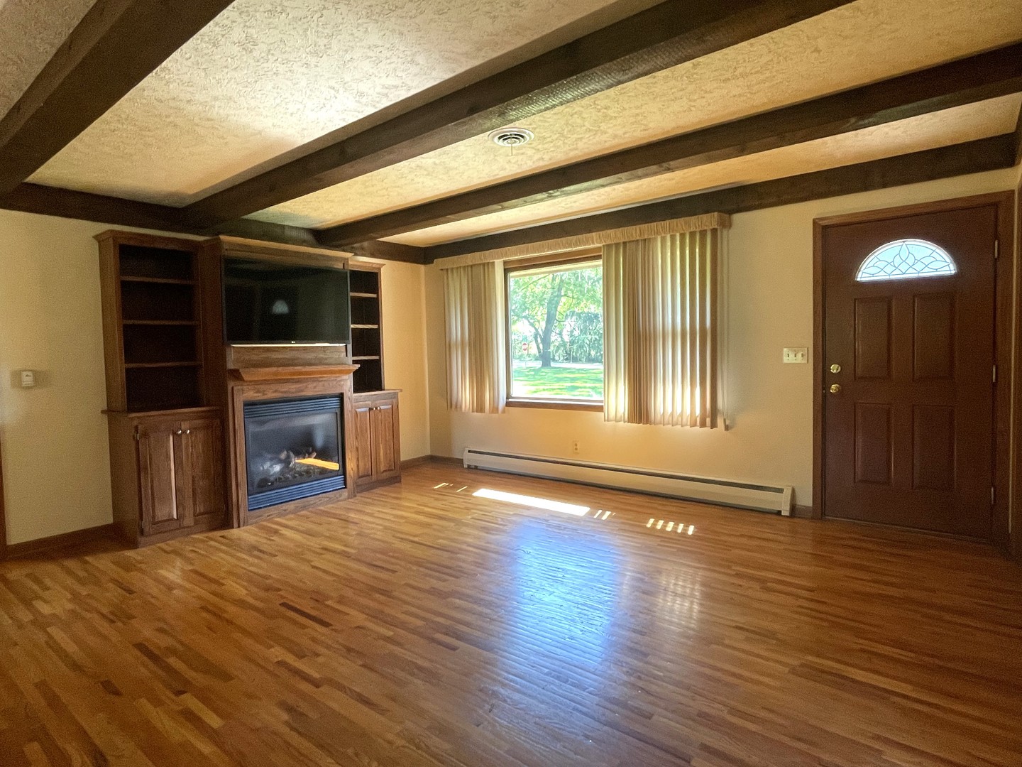 206 Palmyra Road Dixon, IL 61021 - Photo 7 of 46 a view of empty room with wooden floor and fireplace