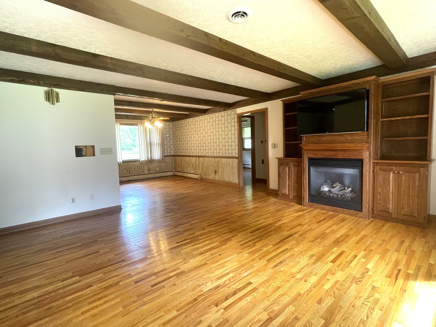 206 Palmyra Road Dixon, IL 61021 - Photo 9 of 46 a view of empty room with wooden floor and fireplace