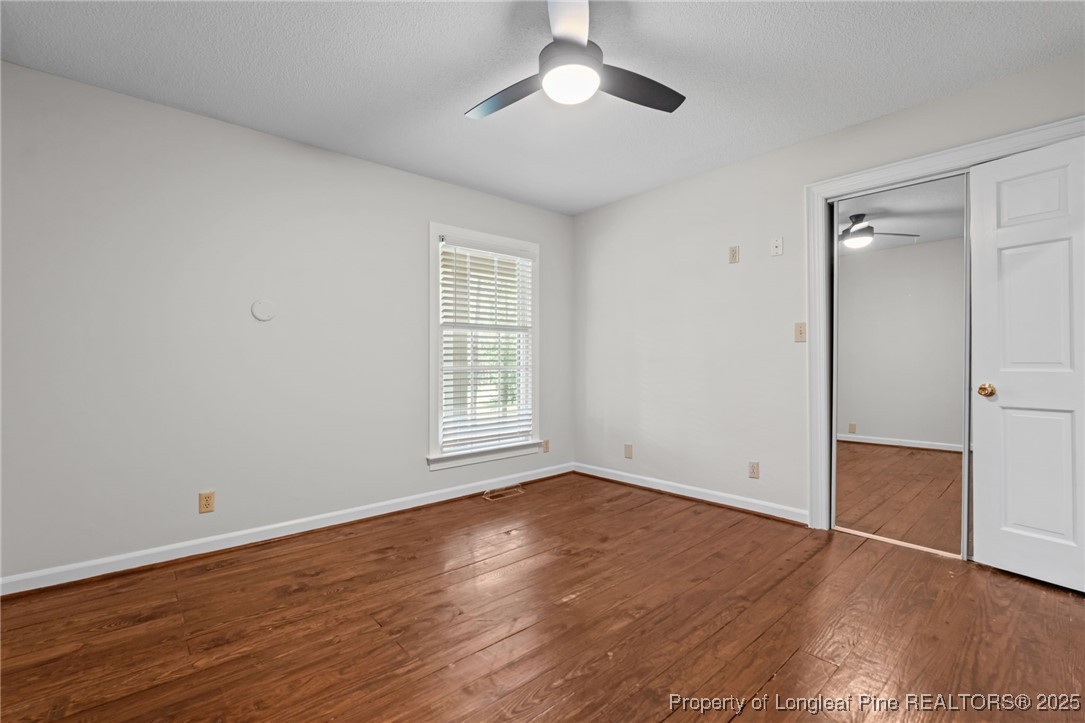 610 Maynard Lake Road Erwin, NC 28339 - Photo 13 of 49 wooden floor in an empty room with a window