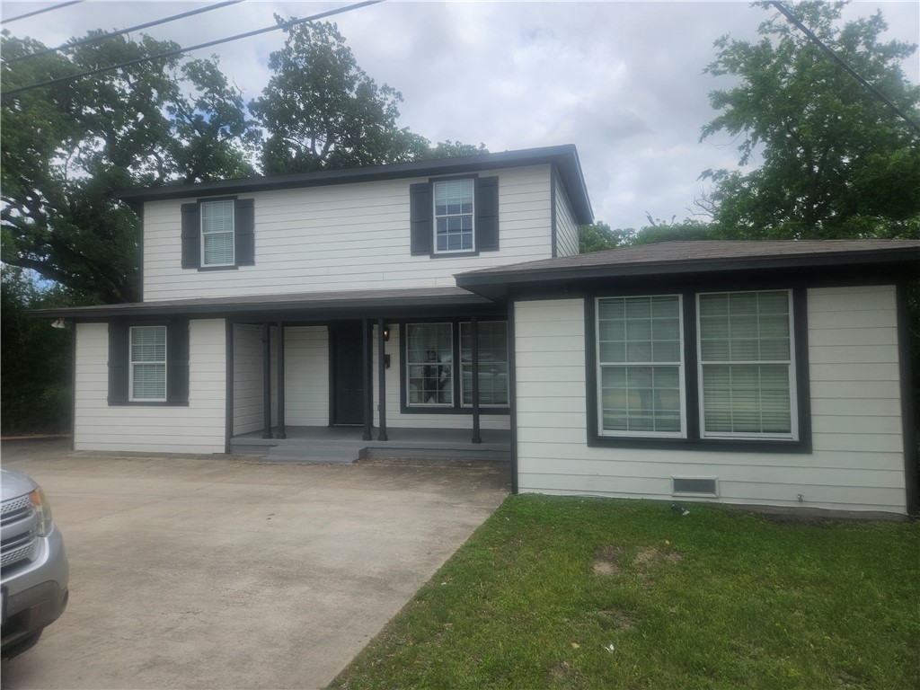 4309 Old College Road Bryan, TX 77801 - Photo 1 of 10 Two-story residence featuring light-colored siding with dark trim and shutters