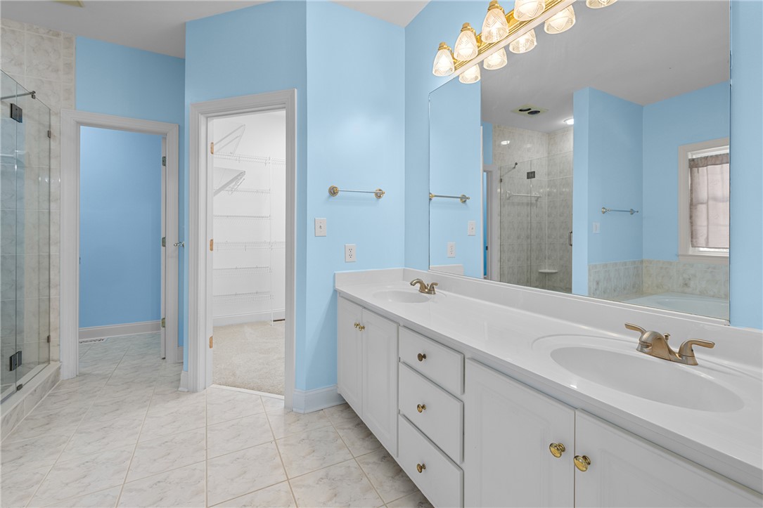 110 Brookstone Way Central, SC 29630 - Photo 23 of 46 This spacious bathroom offers dual vanities, a glass-enclosed shower, and a large mirror.