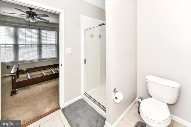 a white toilet sitting next to a bathroom sink