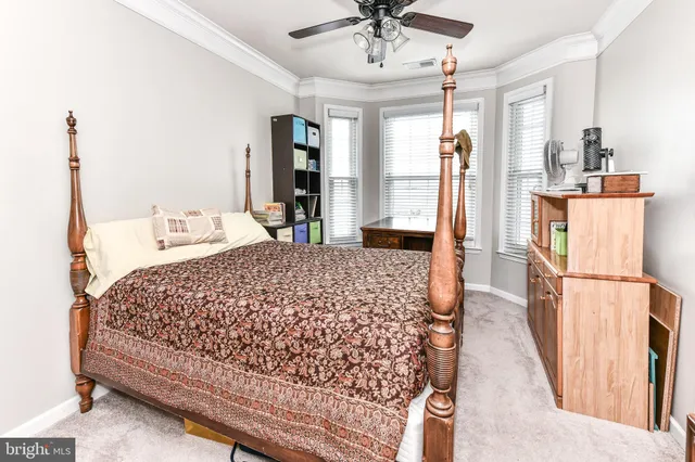 a bedroom with a bed a window and walk in closet