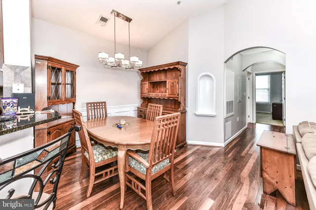 a view of a dining room with furniture and a chandelier