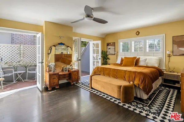 a bedroom with bed and wooden floor