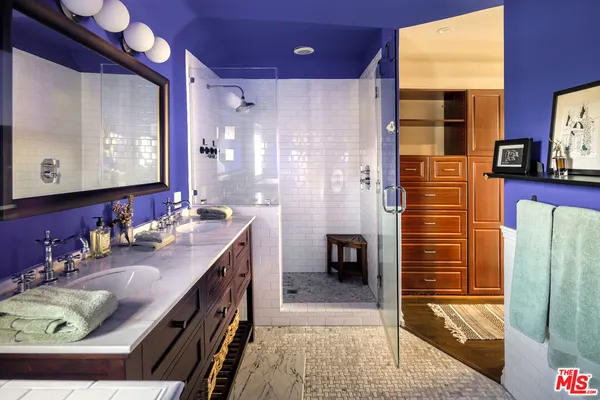 a bathroom with a sink a mirror and a shower