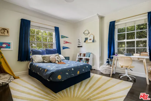 a bedroom with a bed and a large window