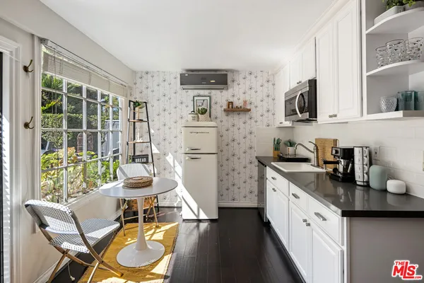 a kitchen with stainless steel appliances kitchen island granite countertop a sink and cabinets
