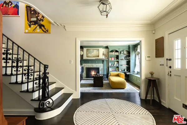 a bedroom with furniture and a wooden floor