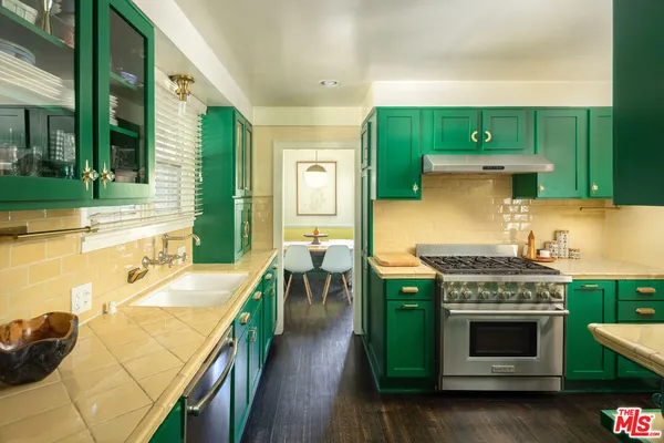 a kitchen with a stove and a wooden floors