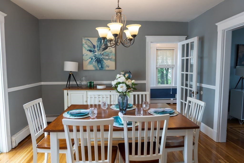 12 Newcastle Road Peabody, MA 01960 - Photo 11 of 35 a dining room filled chandelier and wooden floor