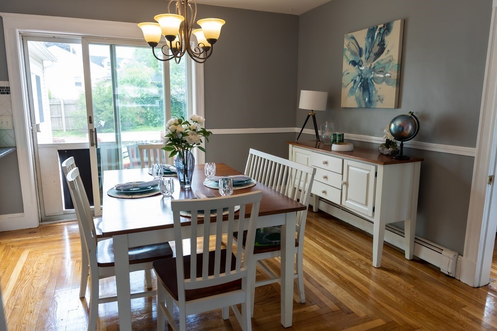 12 Newcastle Road Peabody, MA 01960 - Photo 12 of 35 a view of a dining room with furniture a chandelier and wooden floor
